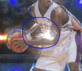 A sports card with surface damage.